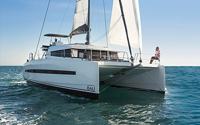 Sitting on the bow of the Bali charter catamaran in Ibiza