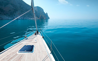 Stunning view of the tip of Cala Jondal and the turquoise blue water from the foredeck of the rental yacht in Ibiza